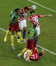 Croatia's Dejan Lovren (6) and Vedran Corluka (5) fight for the ball against Cameroon's Stephane Mbia (17) during their 2014 World Cup Group A soccer match at the Amazonia arena in Manaus June 18, 2014. REUTERS/Andres Stapff (BRAZIL - Tags: SOCCER SPORT WORLD CUP)