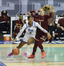 Pittsburgh's Emy Hayford drives the baseline under pressure from Boston College's Cameron Swartz in the opening round of the Atlantic Coast Conference Tournament, Wednesday, March 3, 2021, at the Greensboro Coliseum in Greensboro, N.C. (Walt Unks/The Winston-Salem Journal via AP)