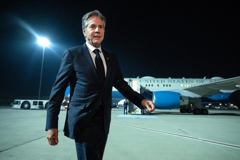 Secretary of State Antony J. Blinken walks on the tarmac at Al Maktoum International Airport in Dubai.