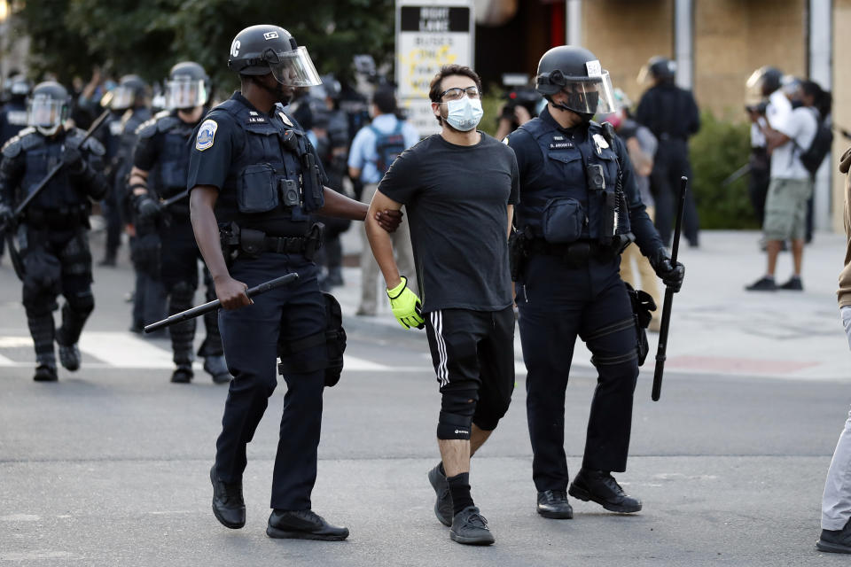 A demonstrator is detained by police during a protest over the death of George Floyd, Monday, June 1, 2020, near the White House in Washington. Floyd died after being restrained by Minneapolis police officers. (AP Photo/Alex Brandon)