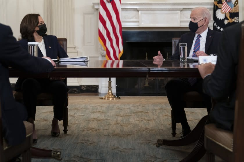 President Joe Biden speaks with Vice President Kamala Harris about the southern border during a meeting in the State Dining Room of the White House, Wednesday, March 24, 2021, in Washington. (AP Photo/Evan Vucci)