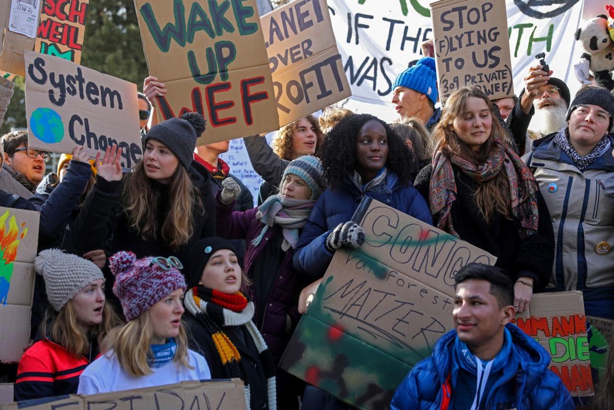 FILE PHOTO: Climate activists Greta Thunberg, centre, Vanessa Nakate, centre right, Isabelle Axelsson, bottom third left, and Luisa Neubauer, centre left, hold placards while taking part in a demonstration on the closing day of the World Economic Forum in Davos, Switzerland, on 24 Jan 2020. (Photo: Simon Dawson/Bloomberg)