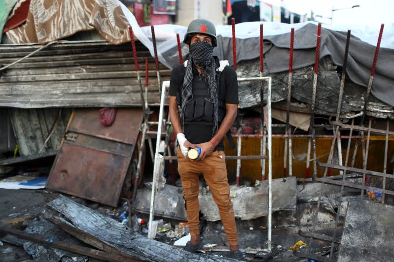 Ahmed, an Iraqi demonstrator, poses for a photograph during the ongoing anti-government protests in Baghdad