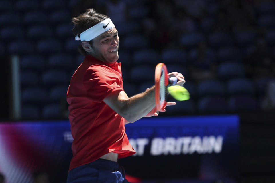 Taylor Fritz of the United States returns a forehand shot to Cameron Norrie of Britain during the United Cup tennis tournament in Perth, Australia, Sunday, Dec. 31, 2023. (AP Photo/Trevor Collens)