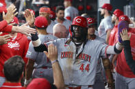 Cincinnati Reds Elly De La Cruz (44) is greeted in the dugout after scoring against the Texas Rangers during the first inning of a baseball game Friday, April 26, 2024, in Arlington, Texas. (AP Photo/Richard W. Rodriguez)