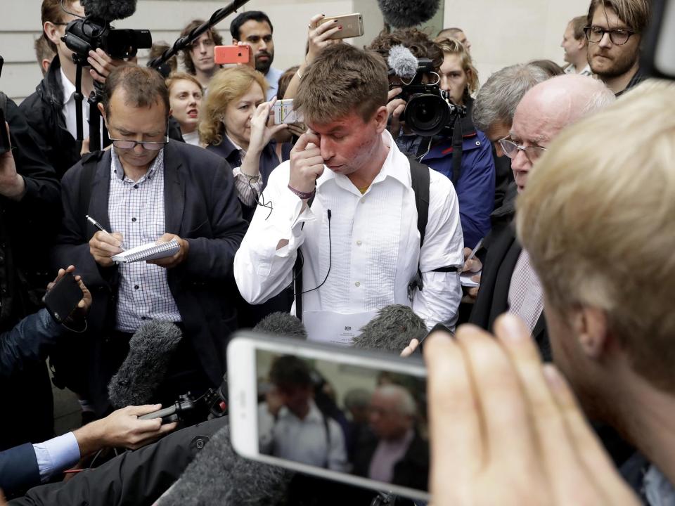 British national Lauri Love, who is accused of hacking into U.S. government computers, wipes away tears while speaking to the media after the ruling that he should be extradited, outside Westminster Magistrates' Court in London: AP