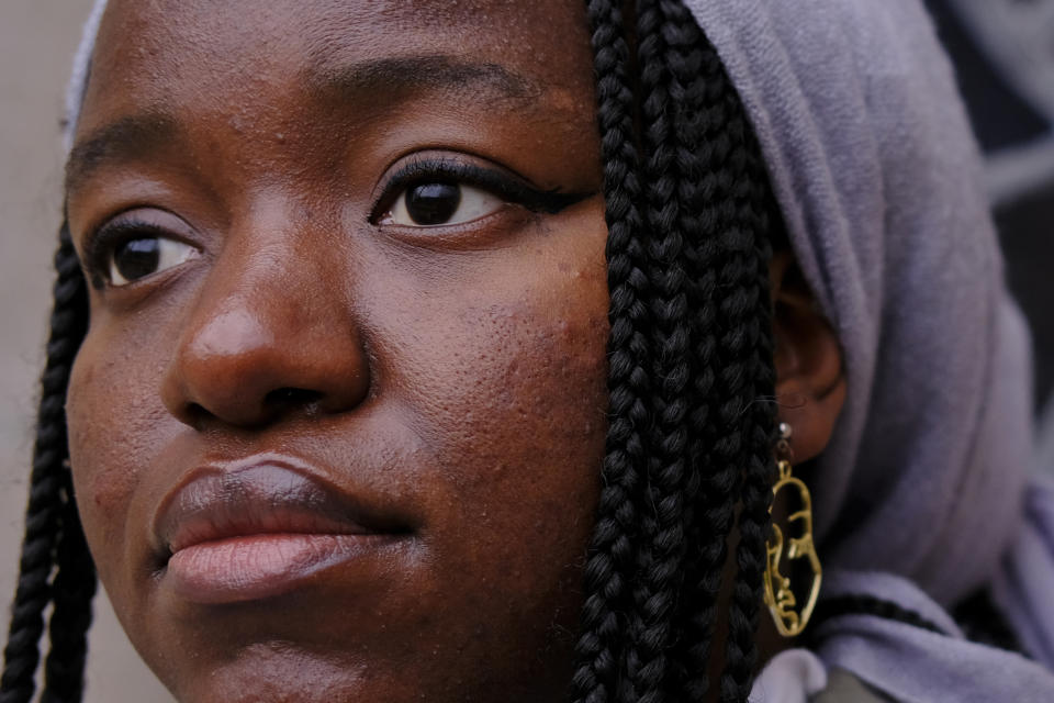 Nathalie Charles poses for a portrait outside the Princeton University Chapel in Princeton, N.J. on Wednesday, Dec. 8, 2021. Charles left her Baptist church at the age of 15 because as a queer woman of Haitian descent, she felt unwelcome in her congregation, with its conservative views on immigration, gender and sexuality. The 18-year-old freshman at Princeton has since identified as atheist, and then agnostic, before embracing a spiritual but not religious life. (AP Photo/Luis Andres Henao)