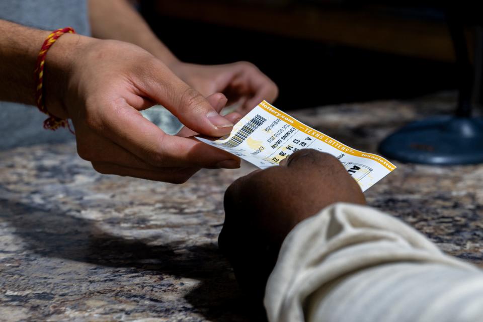 A customer purchases a Powerball lottery ticket at the Brew Market & Cafe on October 10, 2023 in Austin, Texas.