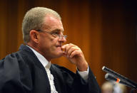 South African chief state prosecutor Gerrie Nel questions Oscar Pistorius in court in Pretoria, South Africa, Monday, April 14, 2014. A judge temporarily adjourned the murder trial of Oscar Pistorius after the athlete started to sob while testifying about the moments before he killed girlfriend Reeva Steenkamp in his home last year. (AP Photo/Antoine de Ras, Pool)
