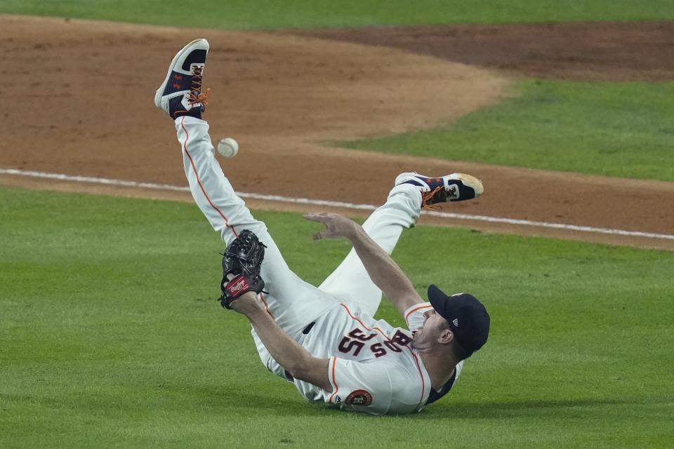 Houston Astros starting pitcher Justin Verlander tries to make a play on a ball hit by Washington Nationals' Ryan Zimmerman during the fourth inning of Game 2 of the baseball World Series Wednesday, Oct. 23, 2019, in Houston. (AP Photo/Eric Gay)