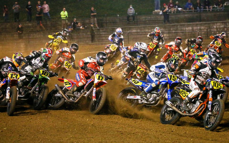 A group of American Flat Track riders attack the half mile course at Volusia Speedway Park.