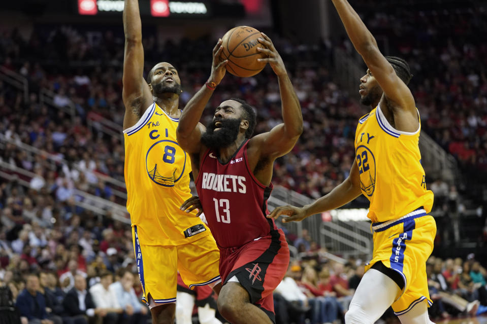 Houston Rockets' James Harden (13) is fouled by Golden State Warriors' Alec Burks (8) as Glenn Robinson III (22) helps defend during the second half of an NBA basketball game Wednesday, Nov. 6, 2019, in Houston. The Rockets won 129-112. (AP Photo/David J. Phillip)