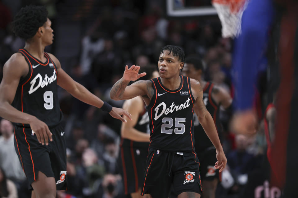 Detroit Pistons guard Marcus Sasser, right, celebrates with Ausar Thompson during the second half of the team's NBA basketball game against the Portland Trail Blazers on Thursday, Feb. 8, 2024, in Portland, Ore. (AP Photo/Howard Lao)