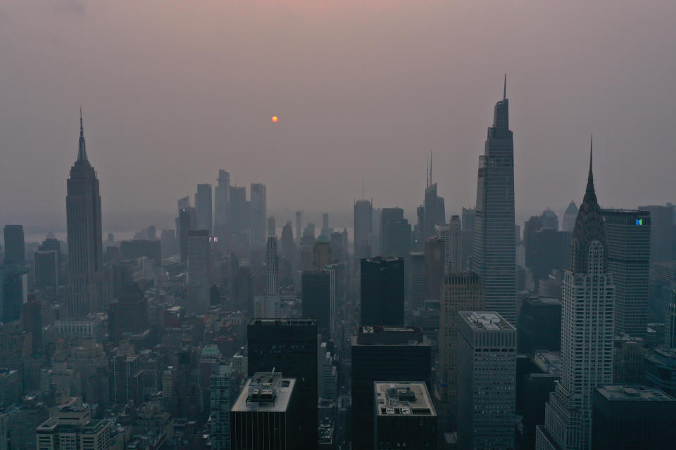 Wildfires burning out of control across the Western U.S. and Canada causes hazy skies throughout NYC and Washington DC July 20, 2021, in New York. Climate is a key factor in ESG investing. (Photo by Lokman Vural Elibol/Anadolu Agency via Getty)