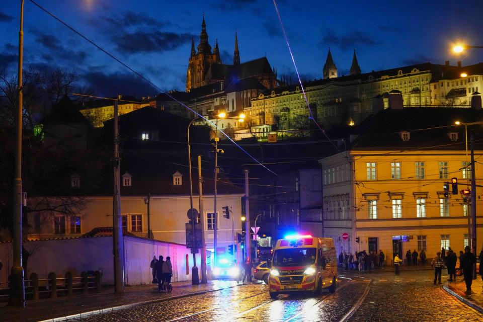 An ambulance drives towards the building housing the Philosophical Faculty of Charles University in downtown Prague, Czech Republic, Thursday, Dec. 21, 2023. Czech police say a shooting in downtown Prague has killed an unspecified number of people and wounded others. (AP Photo/Petr David Josek)