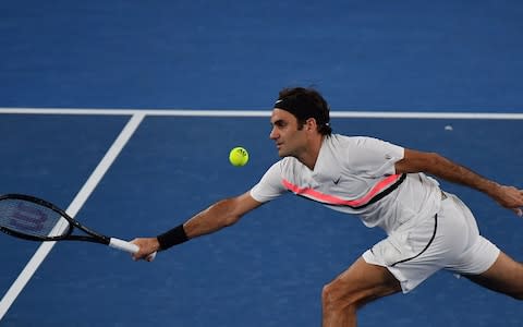 Switzerland's Roger Federer plays a forehand return to Germany's Jan-Lennard Struff during their men's singles second round match on day four of the Australian Open tennis tournament in Melbourne on January 18, 2018 - Credit: AFP 