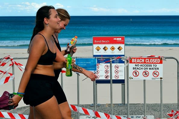 Beachgoers stay out of the water on Bondi Beach in Sydney.