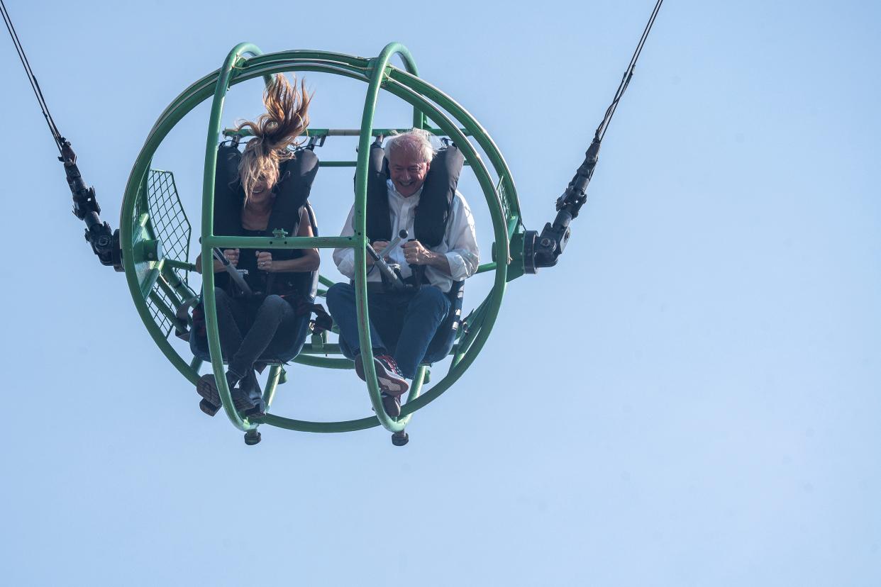 GOP presidential candidate Asa Hutchinson and his daughter Sarah ride the Sling Shot during day 9 of the Iowa State Fair on Friday, August 18, 2023 in Des Moines.