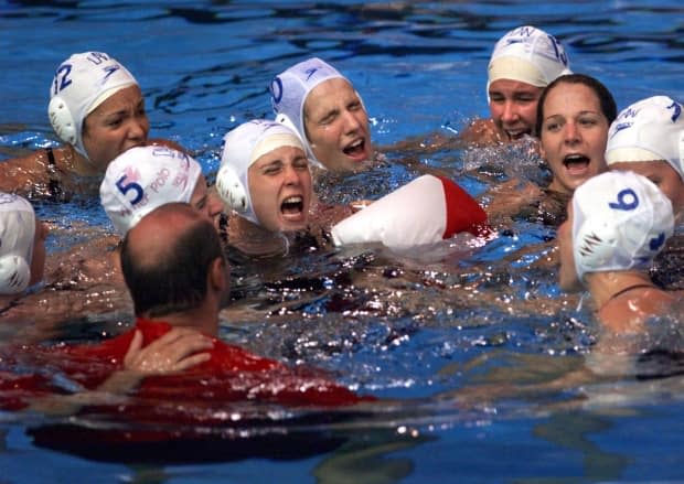 Daniel Berthelette, then coach of the team, joins the celebration in the pool after the team defeated the U.S. to win gold at the 1999 Pan Am Games in Winnipeg.