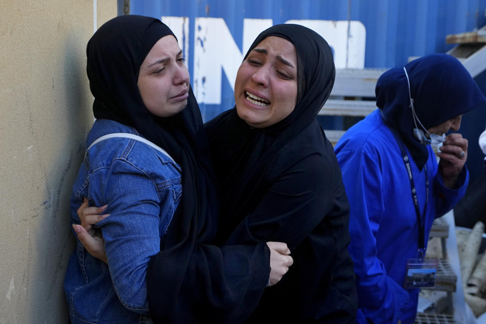 Relatives of a journalist of pan-Arab TV network Al-Mayadeen, who was killed by an Israeli strike, mourn at a hospital in Beirut, Lebanon, Tuesday, Nov. 21, 2023. An Israeli strike on southern Lebanon killed Tuesday two journalists reporting for the Beirut-based Al-Mayadeen TV on the violence along the border with Israel, according to the Lebanese information minister and their TV station. (AP Photo/Bilal Hussein)