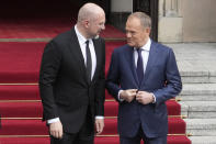 Ukrainian Prime Minister Denys Shmyhal, left, talks with his Polish counterpart, Donald Tusk, right, during a welcome ceremony prior to their talk in Warsaw, Poland, Thursday March 28, 2024. (AP Photo/Czarek Sokolowski)