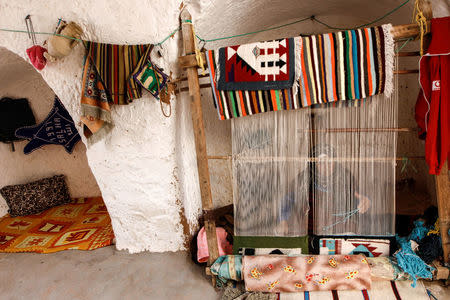 Mounjia, 60, weaves carpet at her troglodyte home in Matmata, Tunisia, February 6, 2018. REUTERS/Zohra Bensemra