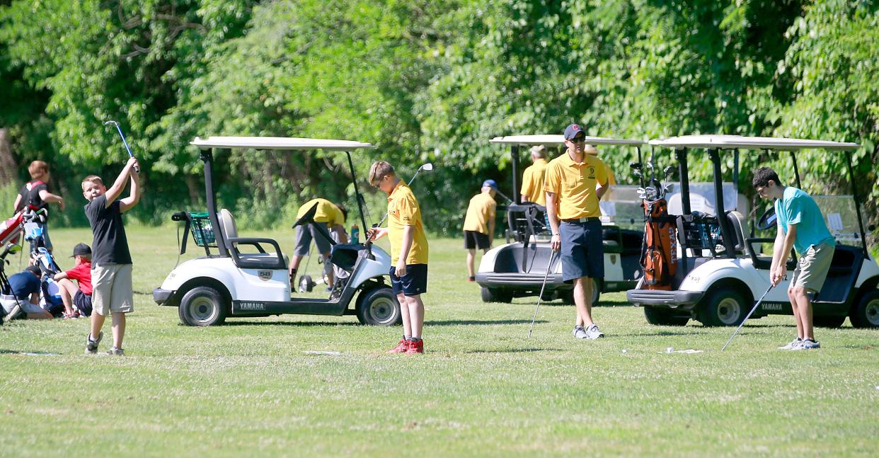 Instructor Kory Oslie watches as Bentley Edwards, Tyler Carpenter and Kaleb Maynard hit at one of the two swing stations at the Brookside Junior Golf program that is celebrating it's 50th year this year on Monday, June 27, 2022. TOM E. PUSKAR/ASHLAND TIMES-GAZETTE