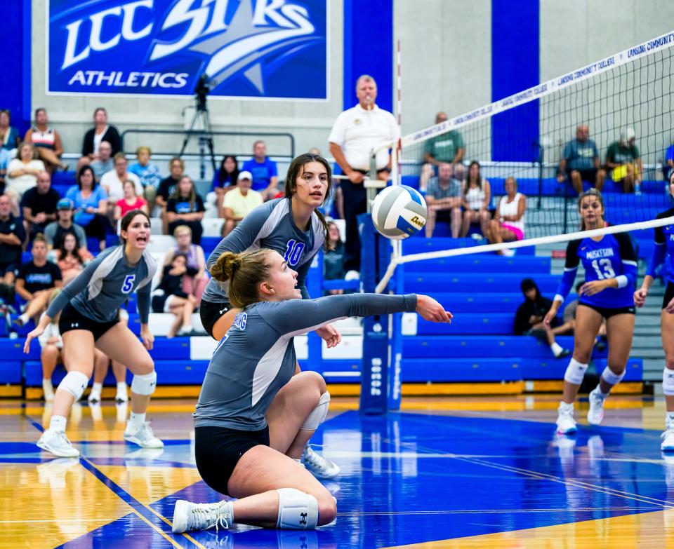 LCC's Lorna Strieff (foreground) digs a Muskegon Community College hit in the third set of their match on Sept. 5.