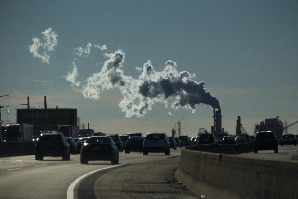 Vehicles move along the The New Jersey Turnpike Way while a Factory emits smoke on November 17, 2017 in Carteret, New Jersey. (Photo by Kena Betancur/VIEWpress/Corbis via Getty Images)