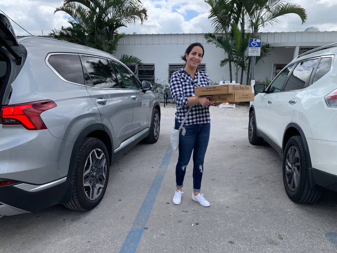 Knaus Berry Farm customer Diley Bernal is a new convert. She heads back to her car on Thursday, Feb. 23, 2023, with a box of cinnamon rolls and a guava pie.