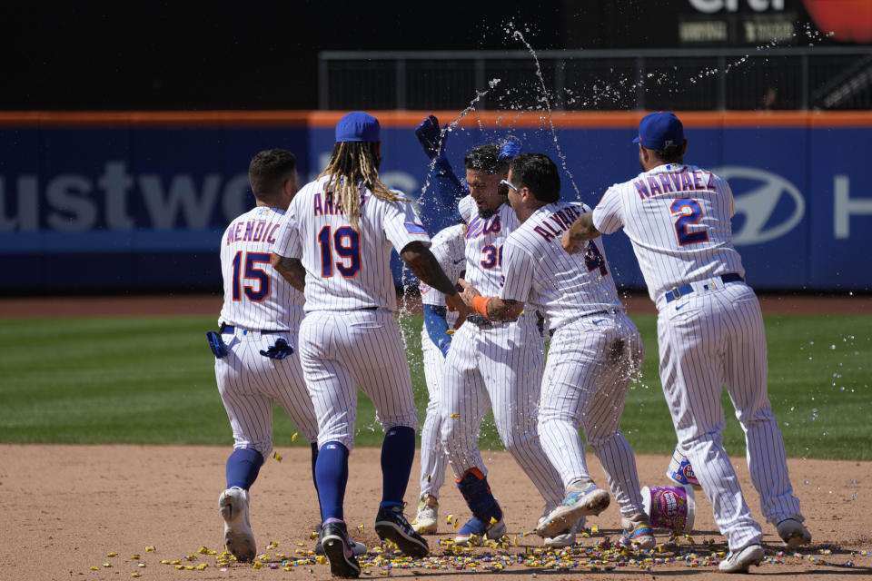 New York Mets' Rafael Ortega (30) celebrates with his teammates after hitting a walk off single during the ninth inning of a baseball game against the Los Angeles Angels, Sunday, Aug. 27, 2023, in New York. The Mets won 3-2. (AP Photo/Mary Altaffer)
