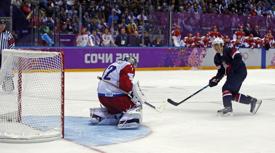 USA forward T.J. Oshie scores the winning goal against Russia goaltender Sergei Bobrovski in a shootout during overtime of a men's ice hockey game at the 2014 Winter Olympics, Saturday, Feb. 15, 2014, in Sochi, Russia. (AP Photo/Julio Cortez)