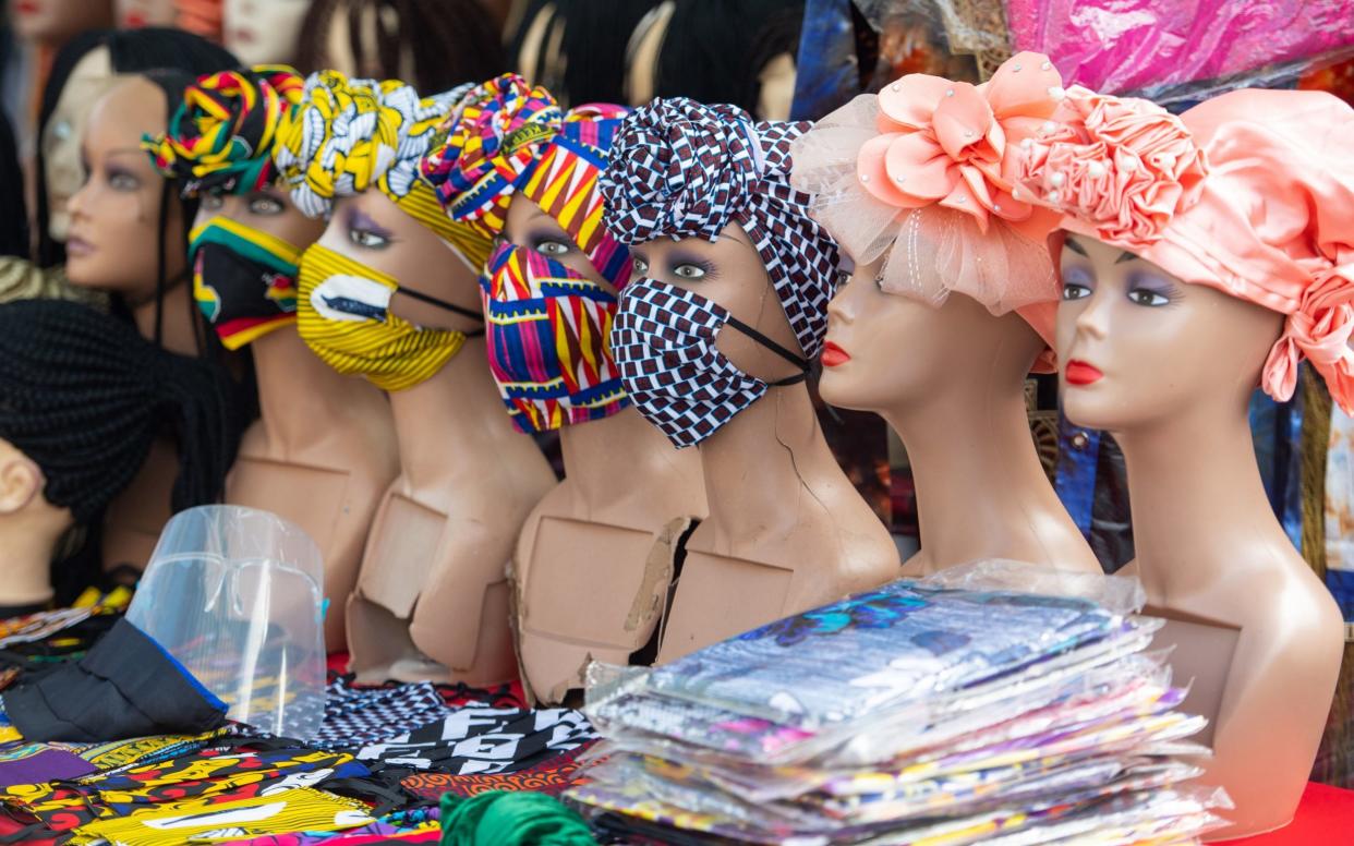 Protective face masks and plastic visors for sale at Ridley Road Market, in Dalston, London - Dominic Lipinski/PA