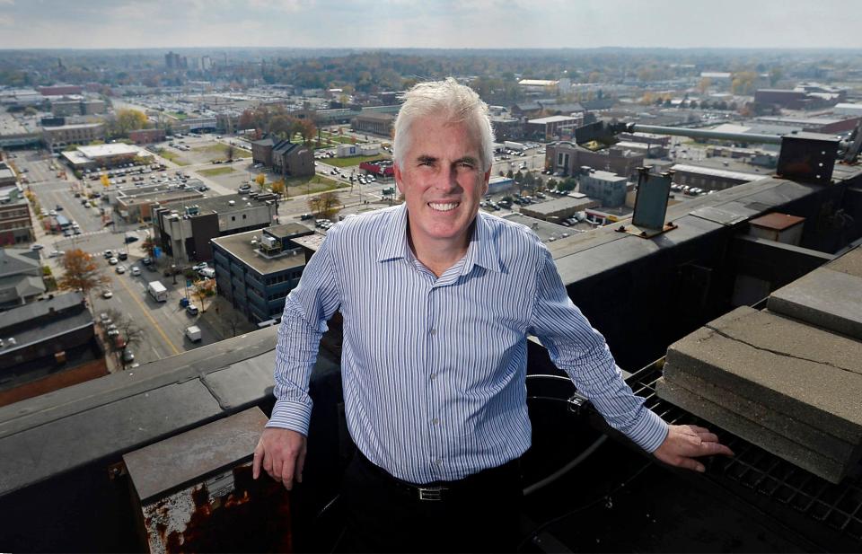 With a view of Erie behind him, real estate developer Tom Kennedy is shown, on Oct. 28, 2014, on the roof of the 14-story Renaissance Centre in Erie. He has sold the building for $2 million.