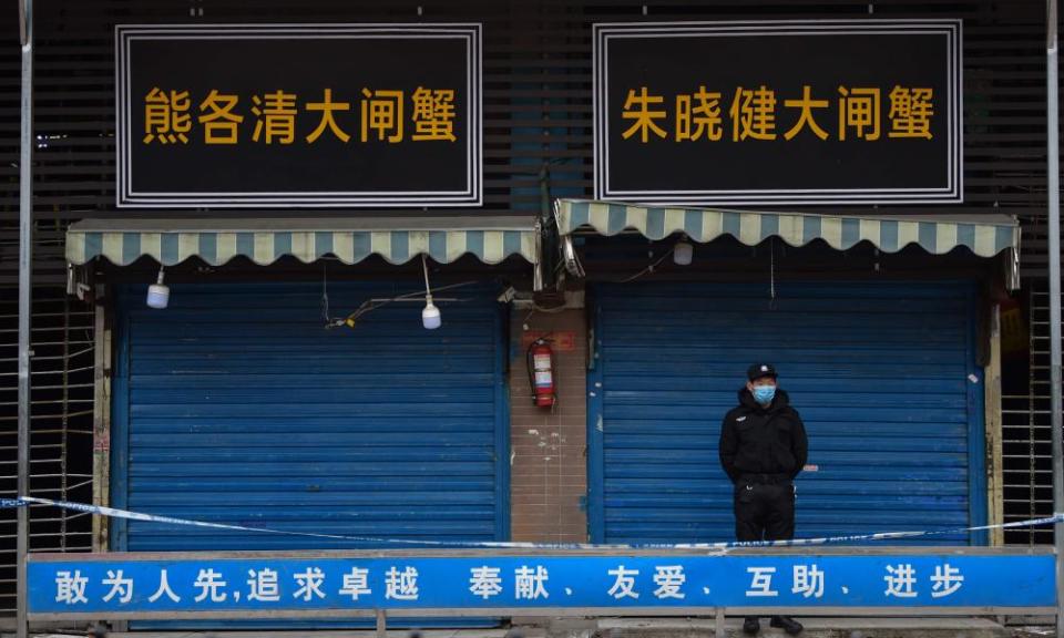 Security guard outside shuttered seafood market