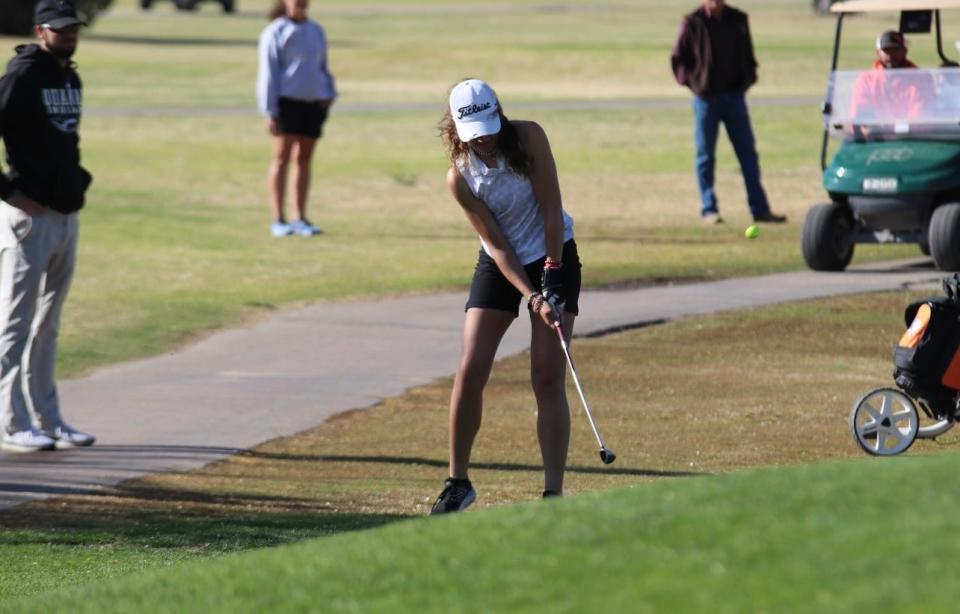 Maggie Golf prepares to swing during a golf tournament in 2023.
