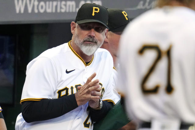 Chicago Cubs manager David Ross stands in the dugout during the