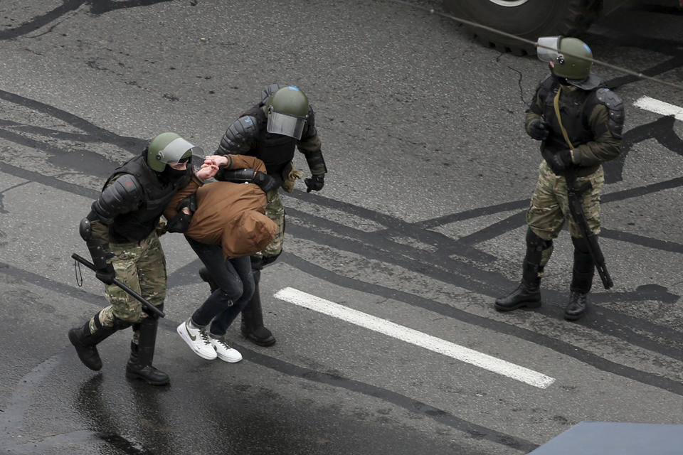 Belarusian riot police a demonstrator during an opposition rally to protest the official presidential election results in Minsk, Belarus, Sunday, Nov. 15, 2020. A Belarusian human rights group says more than 500 people have been arrested in protests around the country calling for authoritarian President Alexander Lukashenko to step down. The Sunday demonstrations continued to wave of near-daily protests that have gripped Belarus since early August. (AP Photo)