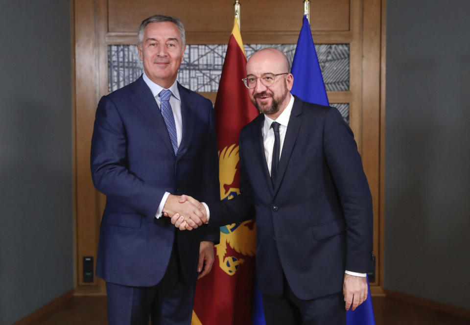 Montenegro's President Milo Dukanovic, left, is welcomed by European Council President Charles Michel prior to a meeting at the Europa building in Brussels, Monday, Feb. 17, 2020. (Stephanie Lecocq, Pool Photo via AP)