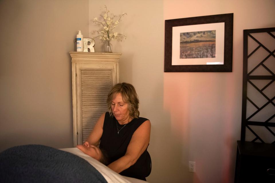 Daisy Oliveira receives a deep-tissue massage from Karla Rice at R&R Tanning and Spa in Battle Creek, Michigan on Thursday, April 14, 2022.