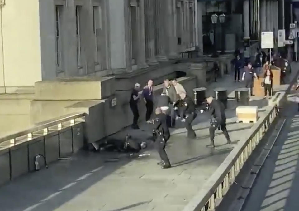 Attacker on ground surrounded by police on London Bridge after killing two innocent people.