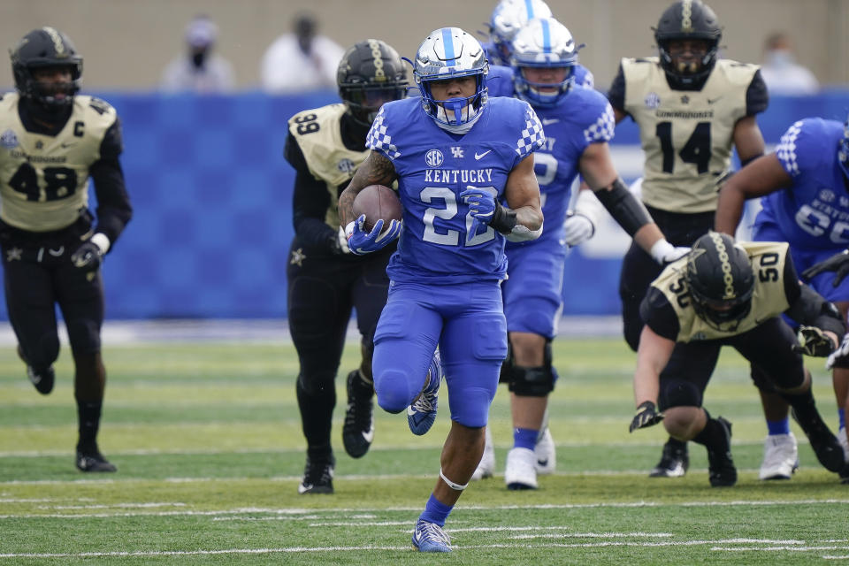 CORRECTS NAME AND POSITION TO RUNNING BACK CHRIS RODRIGUEZ INSTEAD OF LINEBACKER CHRIS OATS - Kentucky running back Chris Rodriguez, center, runs with the ball during the first half of an NCAA college football game against Vanderbilt, Saturday, Nov. 14, 2020, in Lexington, Ky. (AP Photo/Bryan Woolston)