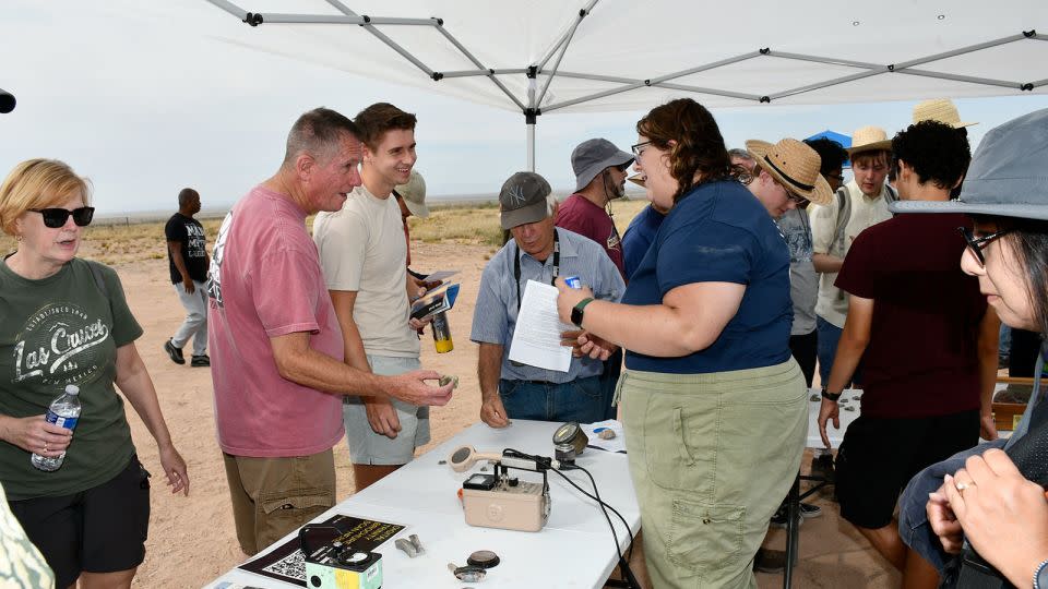 Visitors examine artifacts and information about the site. - Jose Salazar/White Sands Missile Range Public Affairs