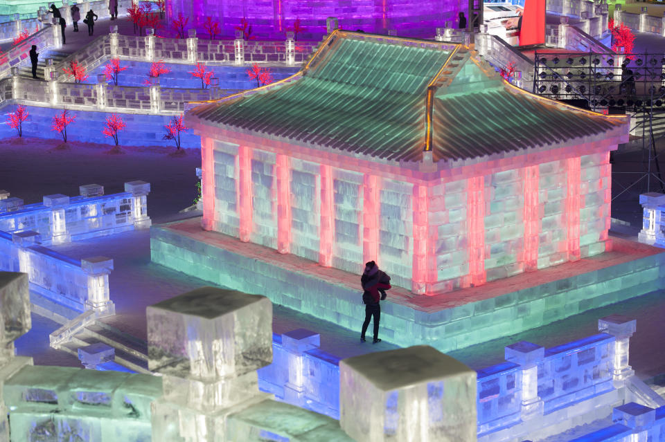 <p>Tourists visit illuminated ice sculptures at Ice and Snow World park on Jan. 4 in Harbin, China. (Photo: Tao Zhang/Getty Images) </p>