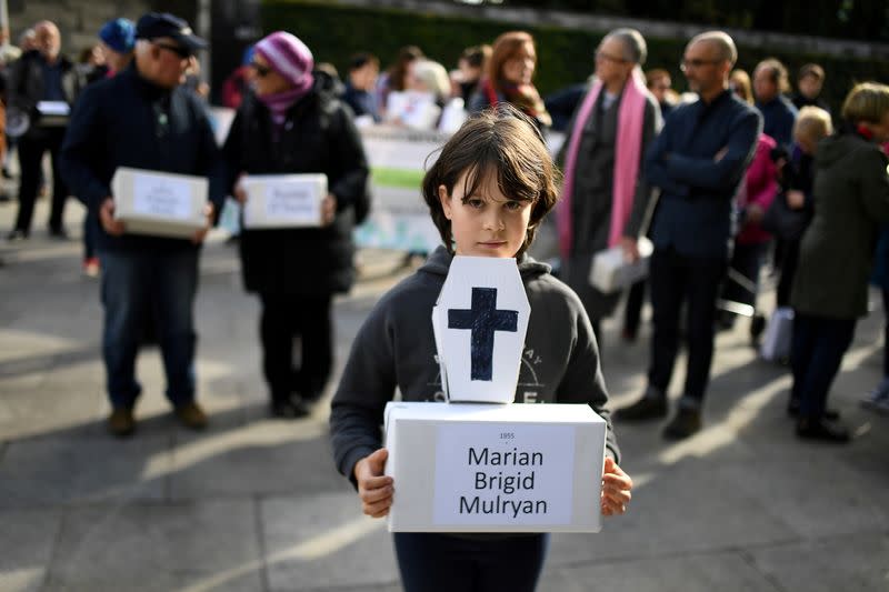 FILE PHOTO: Matilda Kelly holds a funeral box at a funeral procession in remembrance of the bodies of the infants discovered in a septic tank, in 2014, at the Tuam Mother and Baby Home, in Dublin