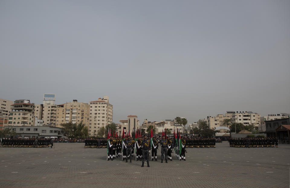 Members of the Palestinian security forces loyal to Hamas, display their skills during a graduation ceremony in Gaza City, Sunday, Dec. 12, 2021. Gaza’s Hamas rulers collect millions of dollars a month in taxes and customs at a crossing on the Egyptian border – providing a valuable source of income that helps it sustain a government and powerful armed wing. After surviving four wars and a nearly 15-year blockade, Hamas has become more resilient and Israel has been forced to accept that its sworn enemy is here to stay. (AP Photo/ Khalil Hamra)