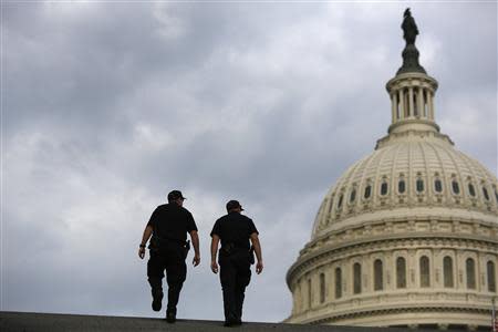 U.S. Capitol Police return to patrol after a brief meeting to discuss how to handle tourists turned away from the shuttered visitor's center at the U.S. Capitol in Washington, October 1, 2013. REUTERS/Jonathan Ernst