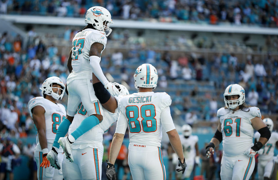 MIAMI GARDENS, FLORIDA - NOVEMBER 28: Jaylen Waddle #17 of the Miami Dolphins celebrates with teammates after scoring a touchdown during the second quarter against the Carolina Panthers at Hard Rock Stadium on November 28, 2021 in Miami Gardens, Florida. (Photo by Cliff Hawkins/Getty Images)