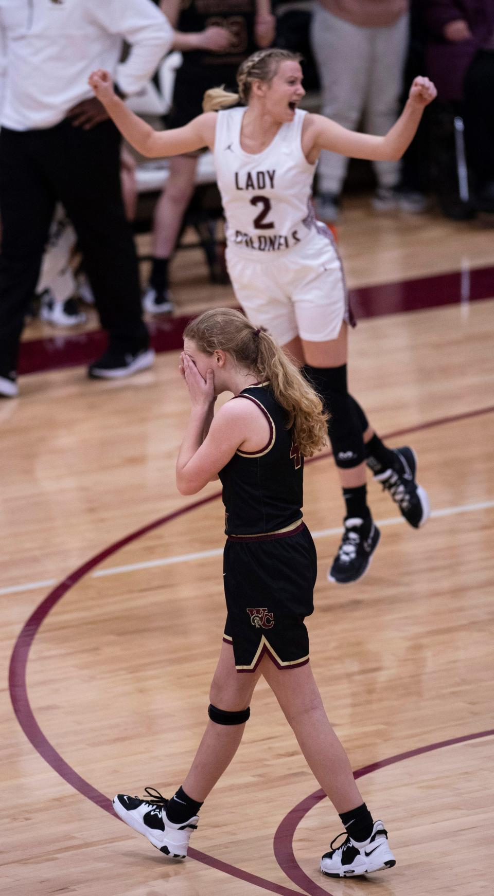 Webster County's Karsyn Cates (4) leaves the court as Henderson County's Mallorie Veal (2) celebrates her team's win after their game at Henderson County High School Tuesday night, Feb. 8, 2022. Henderson County held a one point lead with a half-second left on the clock when Cates, a freshman with only one other free throw attempt on the season, had to step to the line for three free throws. She missed all three and Henderson won the game 45-44.