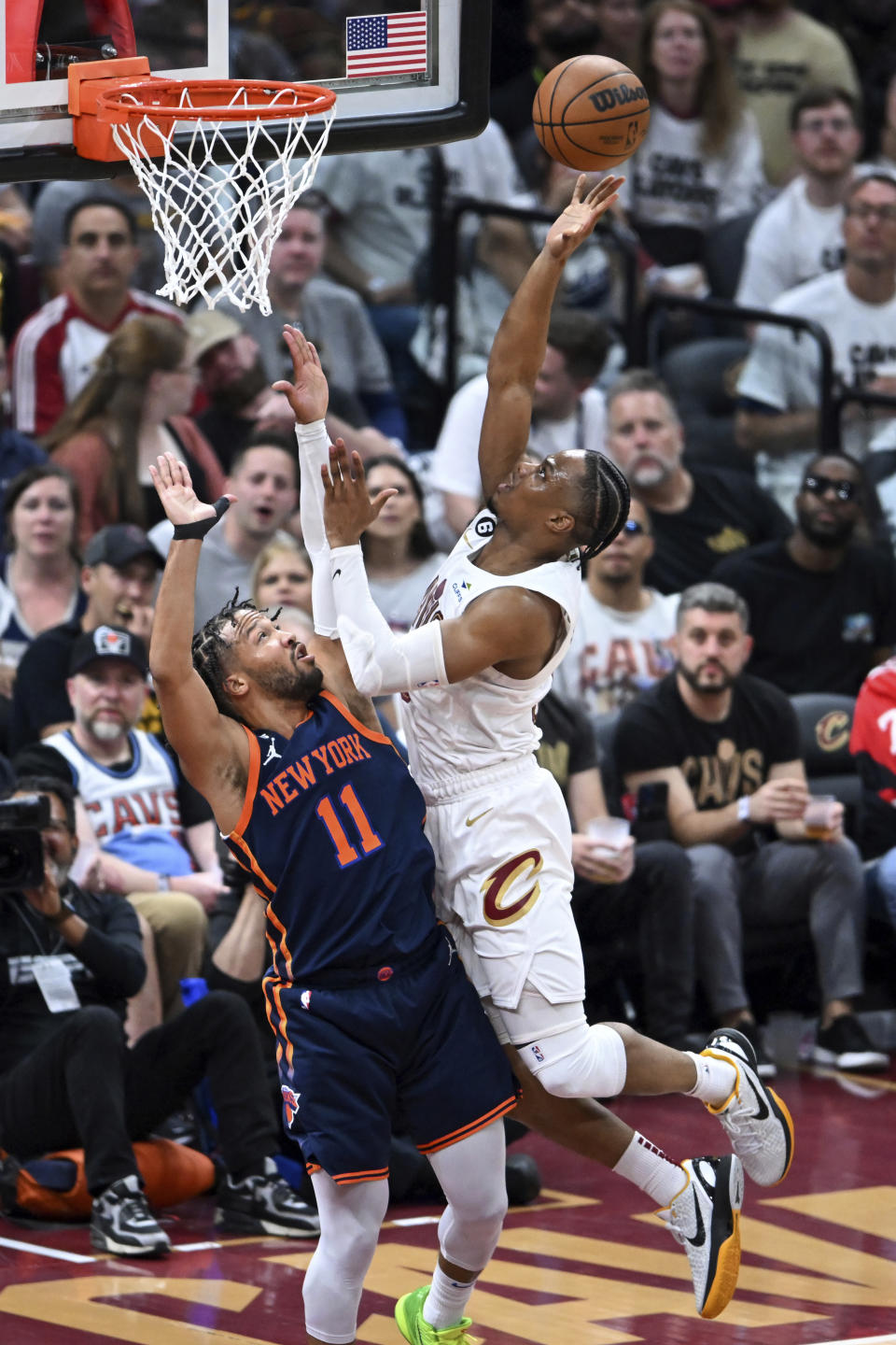 Cleveland Cavaliers' Isaac Okoro shoots against New York Knicks' Jalen Brunson during the second half of Game 1 in a first-round NBA basketball playoffs series Saturday, April 15, 2023, in Cleveland. (AP Photo/Nick Cammett)